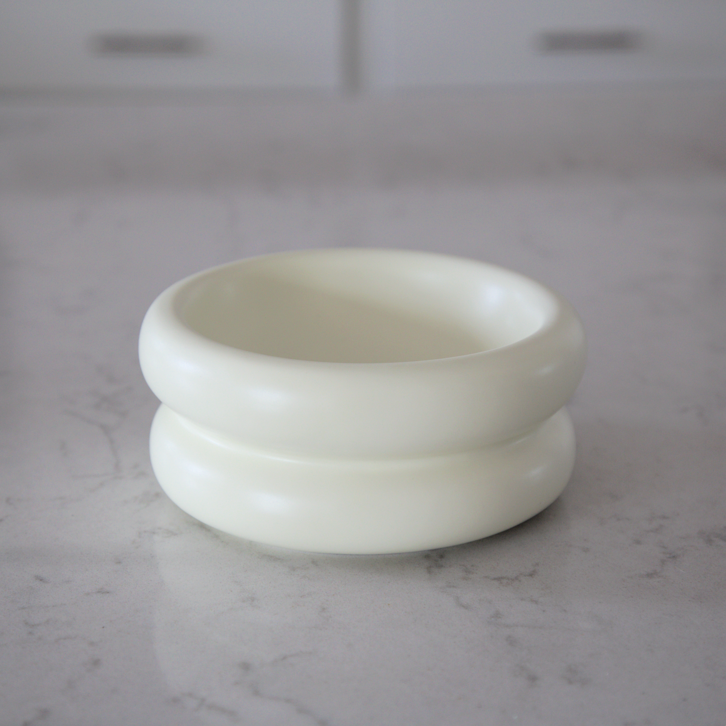 modern stylish elevated cat bowl on marble kitchen counter