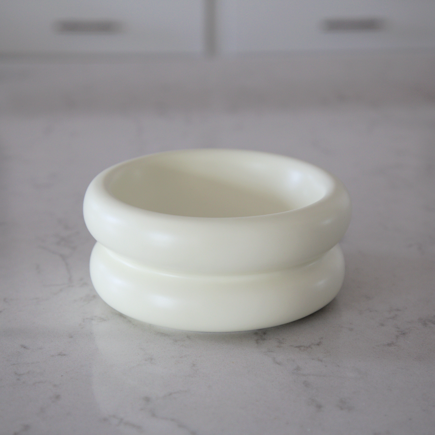 modern stylish elevated cat bowl on marble kitchen counter that prevents whisker fatigue with wide and shallow design
