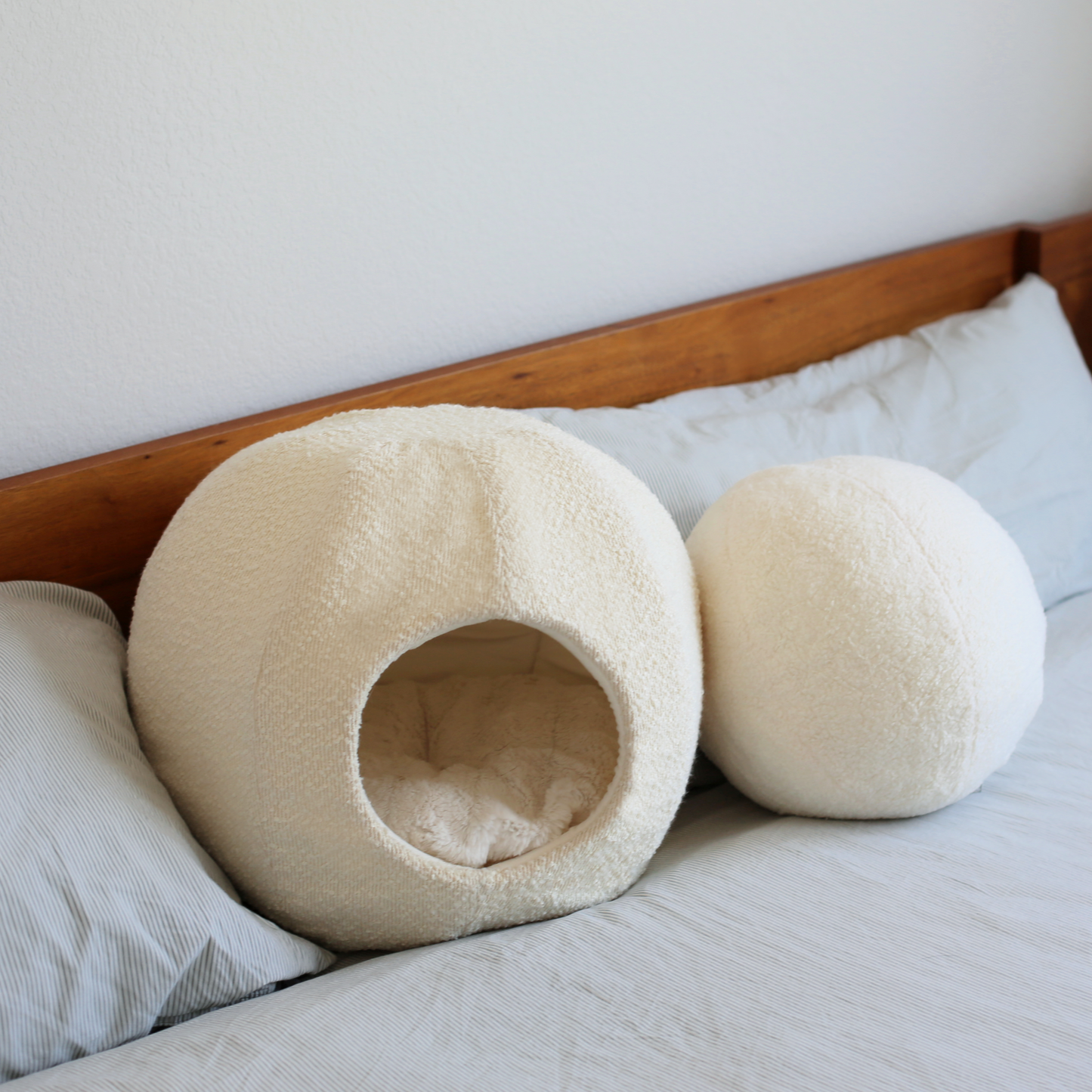 modern white boucle cat cave and cat bed on modern home bed with round ball cushion pillow very aesthetic by catenary