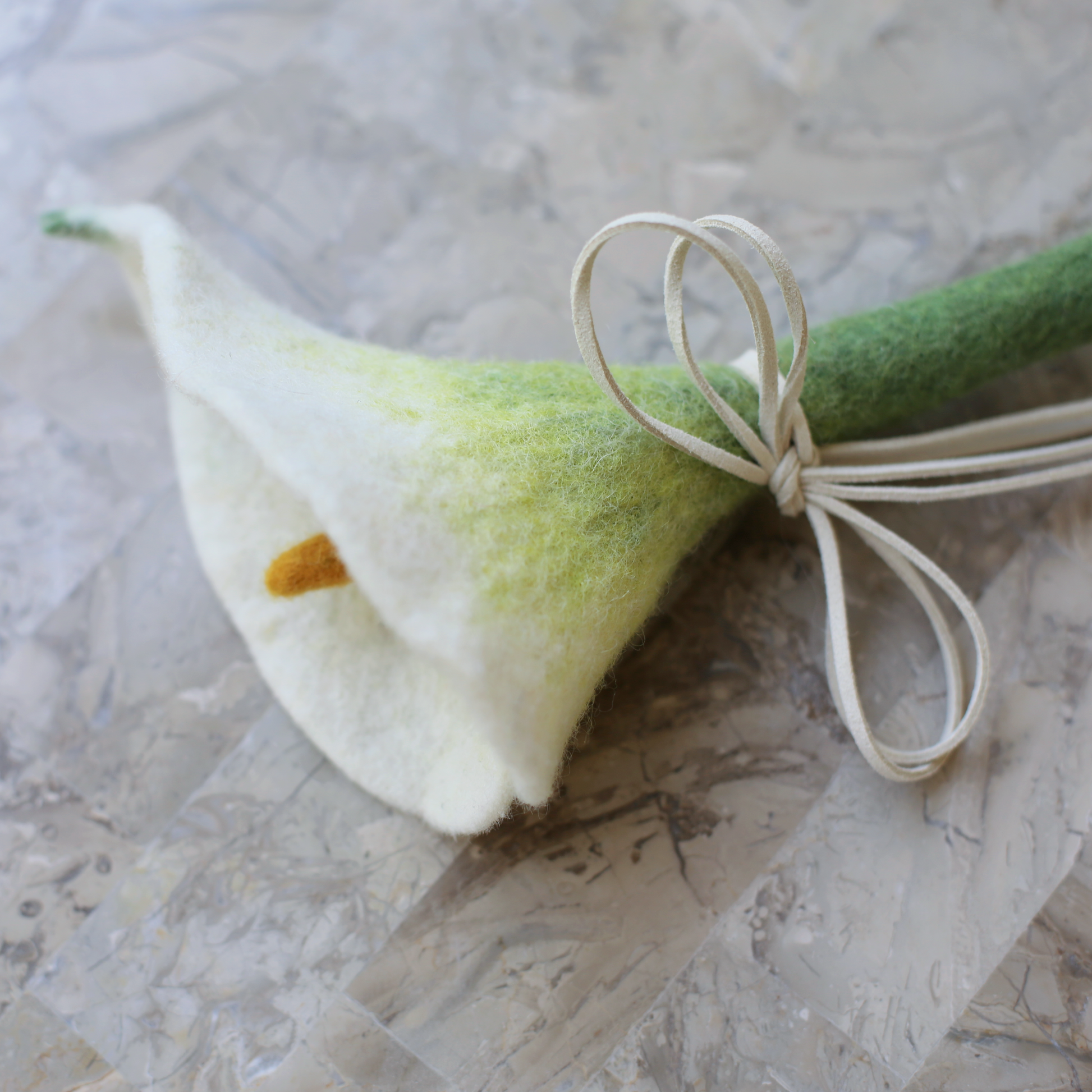close up of wool aesthetic cat toy wand by catenary home in the shape of a calla lily teaser toy modern cat furniture