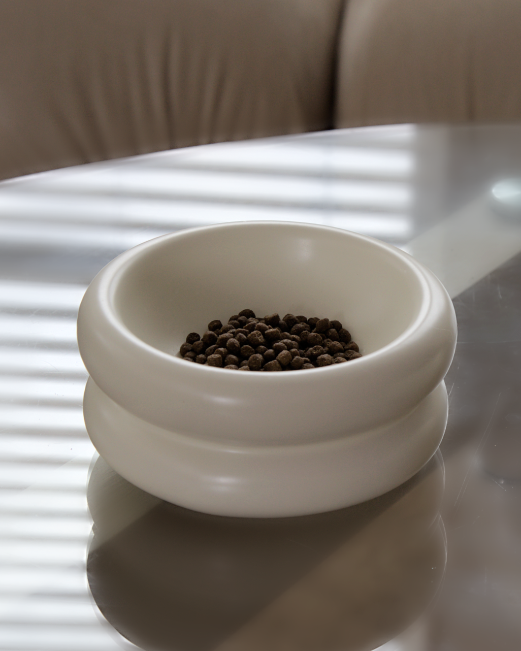 elevated cat bowl also known as raised cat bowl with whisker fatigue prevention that is the best cat bowls  by catenary home modern cat furniture company with cat food inside of the ceramic cat bowl on top of glass table