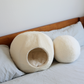 modern white boucle cat cave and cat bed on modern home bed with round ball cushion pillow very aesthetic by catenary