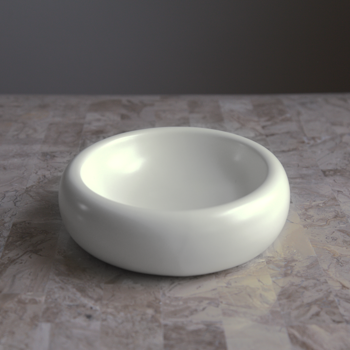 catenary white ceramic cat bowl on beige marble table that prevents whisker fatigue with wide and shallow design